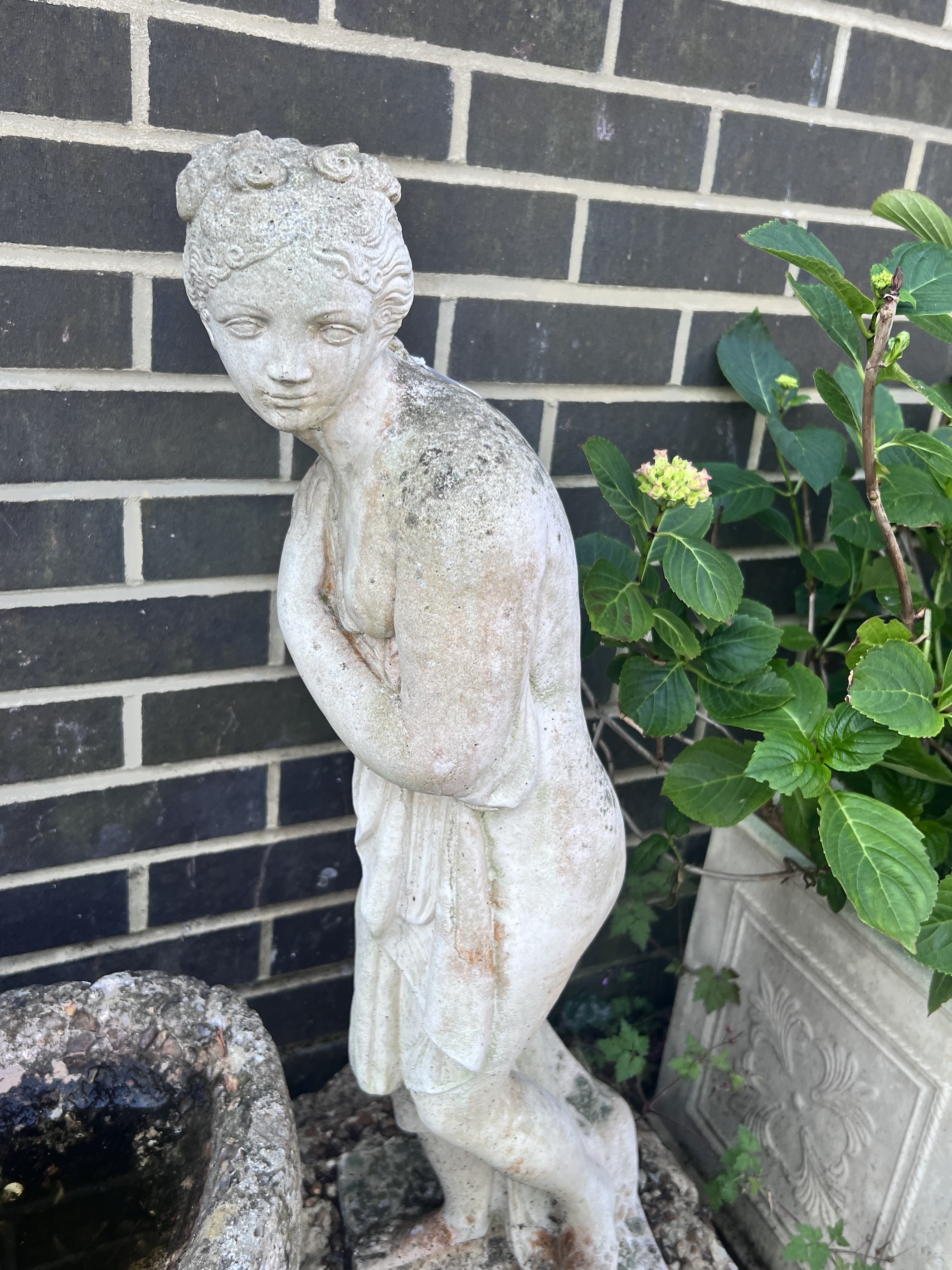 A reconstituted stone female bather garden ornament, height 78cm, together with a stone seated dog ornament